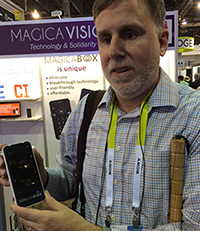 Paul Schroeder at the MagicaVision booth, trying their Android phone