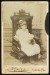 Thumbnail of Photograph of Helen Keller age 7 sitting in a wooden chair with a...