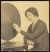 Thumbnail of Photograph of Helen Keller seated and feeling the vibrations of a...
