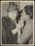 Thumbnail of Photograph taken indoors of a woman holding Helen Keller's hand a...