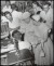 Thumbnail of Photograph taken indoors of Helen Keller visiting a workshop for ...