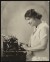 Thumbnail of Photograph taken indoors of Helen Keller working at a typewriter.