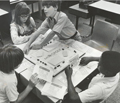 Visually impaired students playing an accessible version of Monopoly, in a classroom setting