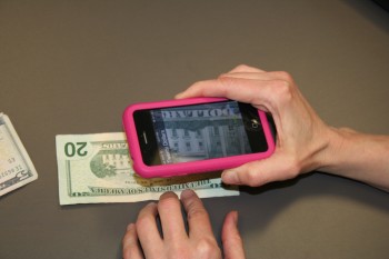 Photo of the LookTel iPhone app being demonstrated on a $20 bill