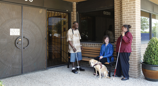 volunteers chat outside the Center on Vision Loss