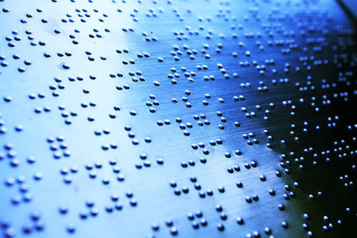 Plain braille page, macro and blue-toned.