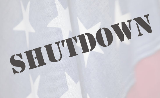 The word 'shutdown' stenciled over the United States flag.