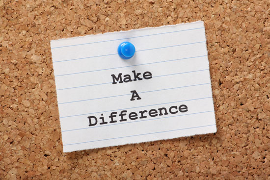 The phrase 'Make A Difference' on a paper note, pinned to a cork board. 