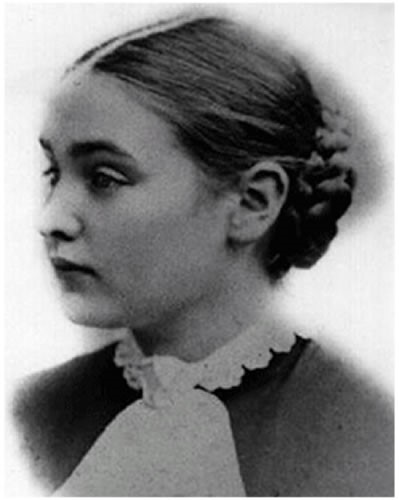 This three-quarter profile of Anne's head and shoulders shows her at age 15. Her hair is parted in the center, pulled back, and braided into a bun at the back of her head. Her dress has a round decorative collar. Circa 1881.