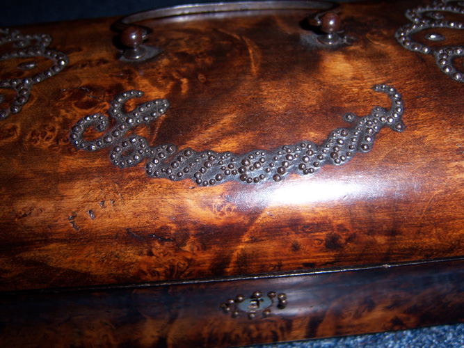 An American wooden box with nails hammered into the wood forming the word "Souvenir." Louis learned to read words by feeling nails in much the same way. No date.