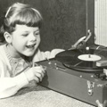 girl listening to a Talking Book with a huge smile on her face, circa 1930s