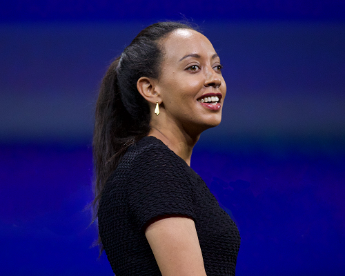 Haben Girma, a woman with long black hair wearing a dark short-sleeved dress.