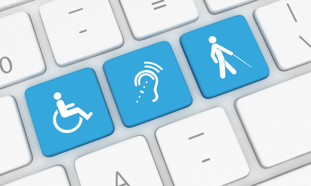 Keyboard with blue and white keys that show the wheelchair, assistive listening device, and person with white cane icons. 