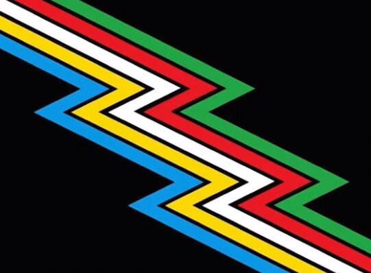Disability Pride Flag - a black background with five zigzag lines colored blue, yellow, white, red, and green going diagonally across. 