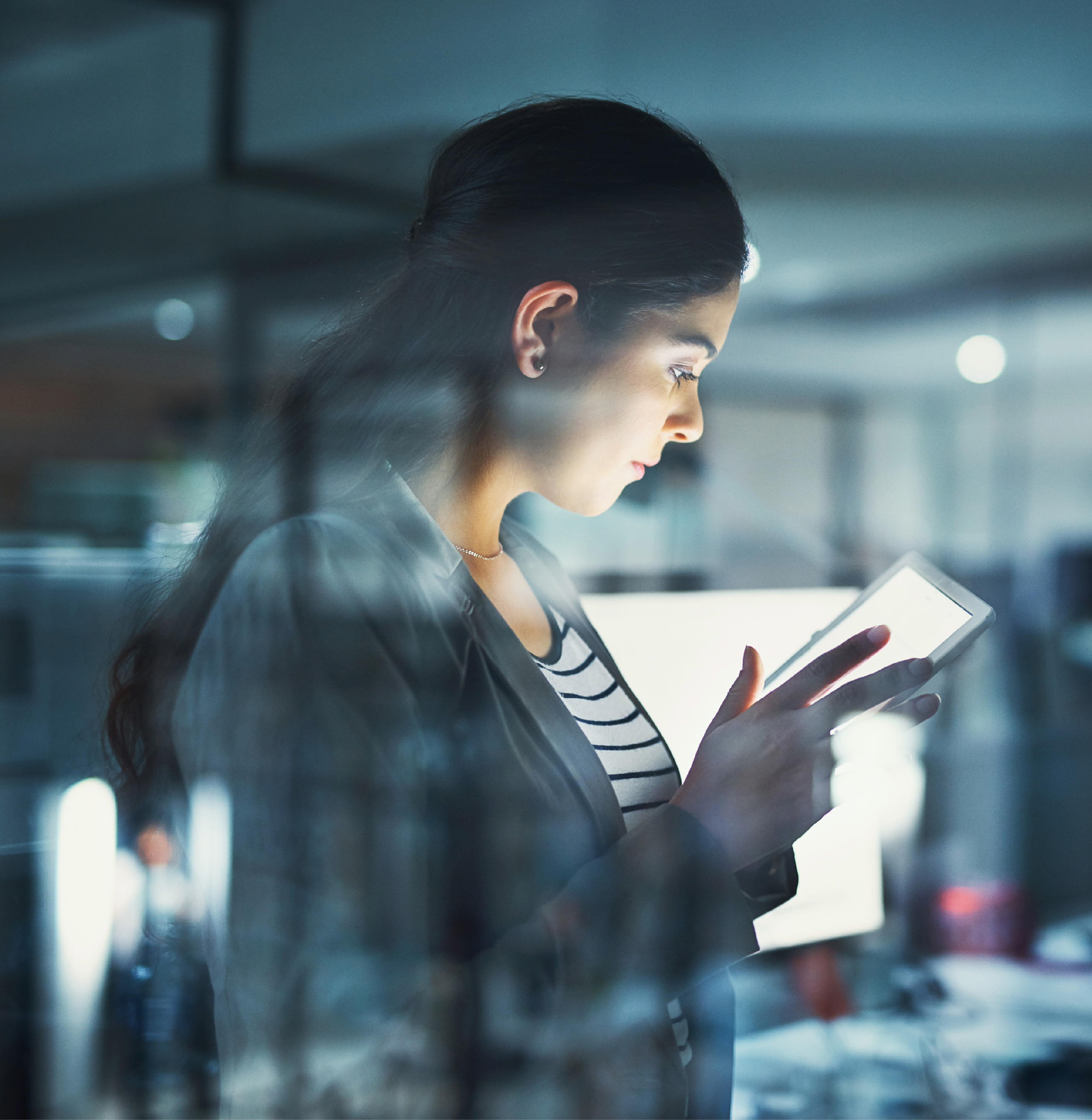 A woman uses a tablet at work.