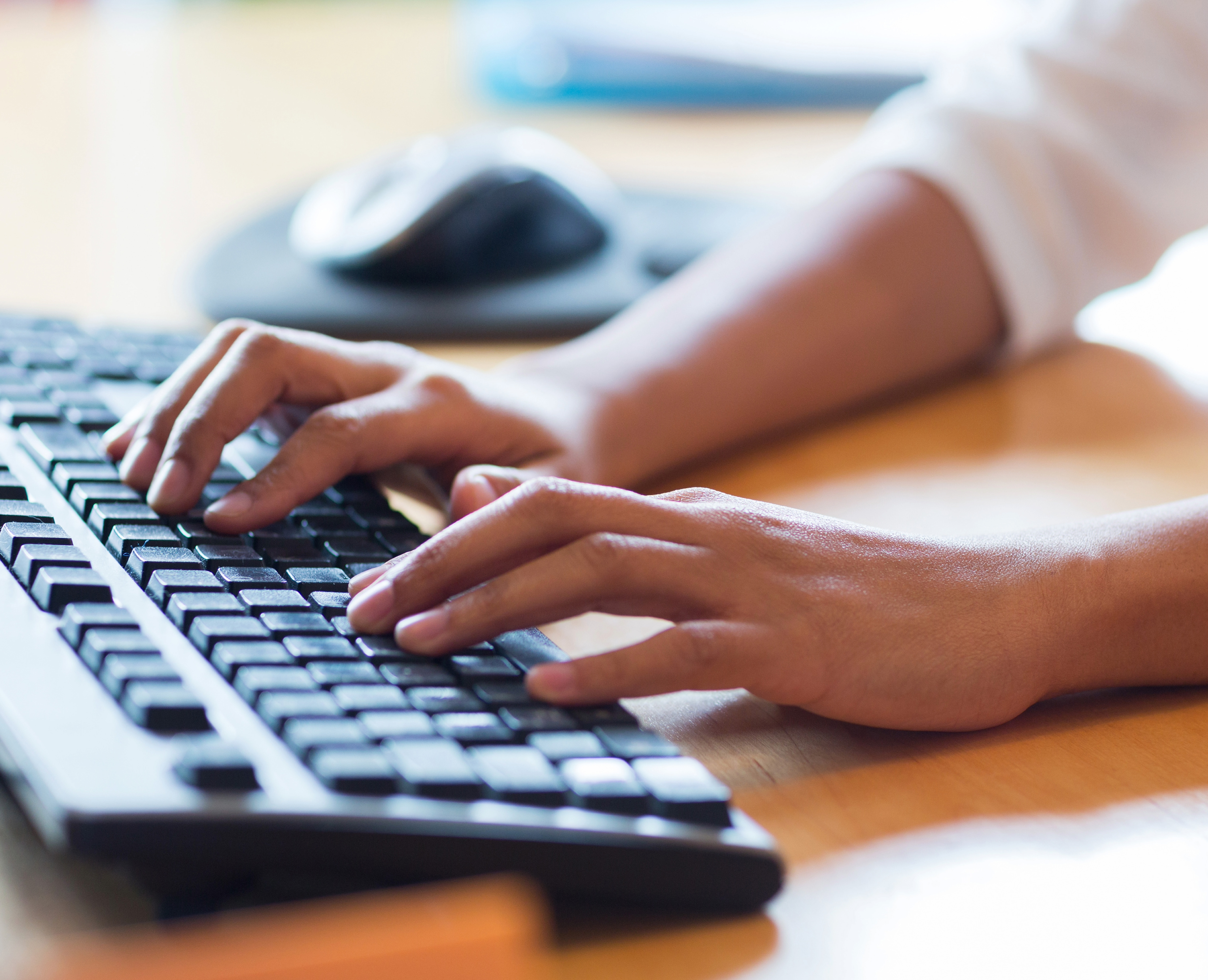 Person typing on a keyboard.