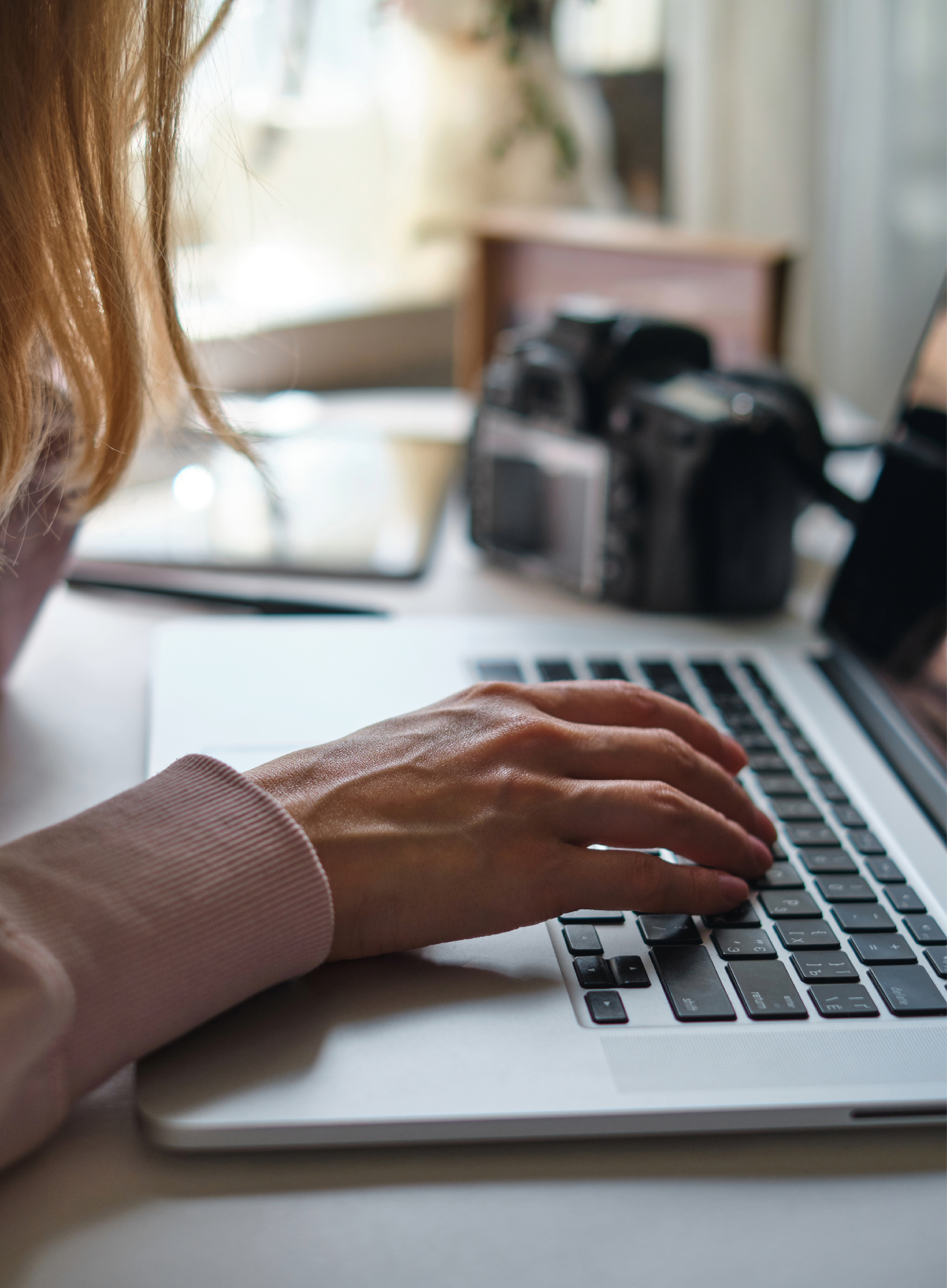 A woman types on a computer.