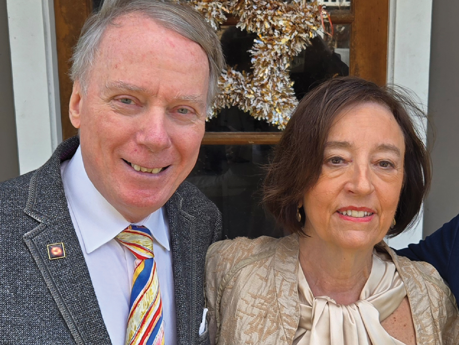 A man with short salt-and-pepper hair and woman with chin-length brown hair smile.