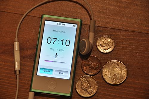 green iPod Nano and mic, next to some coins for size comparison