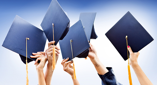 hands tossing graduation caps n the air