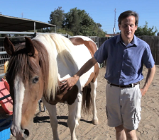 Rick Boggs with his hand on his horse