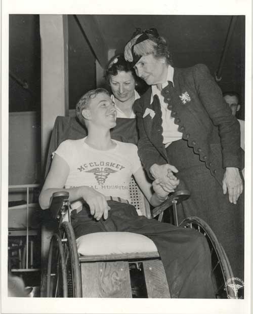 B/w photo of Helen Keller with man in wheelchair
