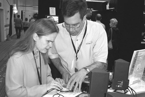 Figure 1: Photograph of Deborah Kendrick and a VisuAide representative using the Victor Reader Vibe DAISY book player.