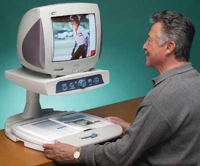 Figure 1: Photo of a man looking at a picture of a baseball player with a Merlin CCTV.