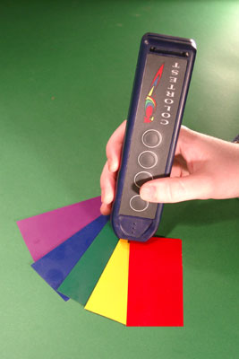 The ColorTest Memo being held against five swatches of different colors.