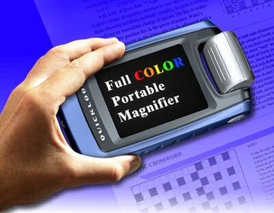 Photo of a hand holding a pocket-size magnifying device over a newspaper. The screen displays the words "Full COLOR Portable Magnifier."