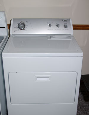 Photo of a front-loading dryer showing turn-knob controls.