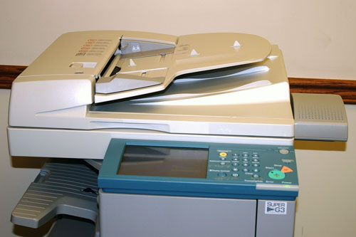 Photo of Canon photocopier with a small speaker on the right side.