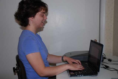 Photo of Annie typing on her laptop computer.