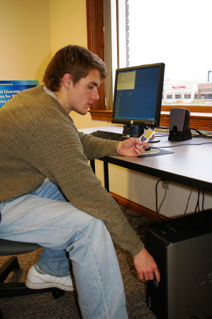 An AFB TECH intern transfering data from the SensoCard to a PC.