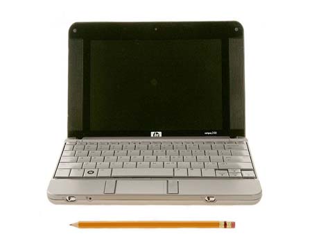 Product shot of HP netbook, including a pencil to show scale. The netbook is just slightly wider than a sharpened pencil is long. 