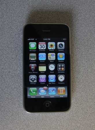 The iPhone's home screen shows icons for various standard apps, as well as status indicators such as signal strength, service provider, current time, and battery strength