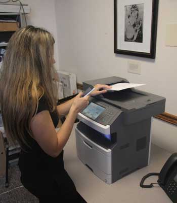 A visually impaired employee using the Lexmark app on her iPhone to control the copy machine