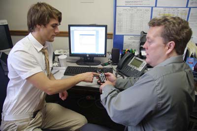 Two men in an office setting, testing the PTP1