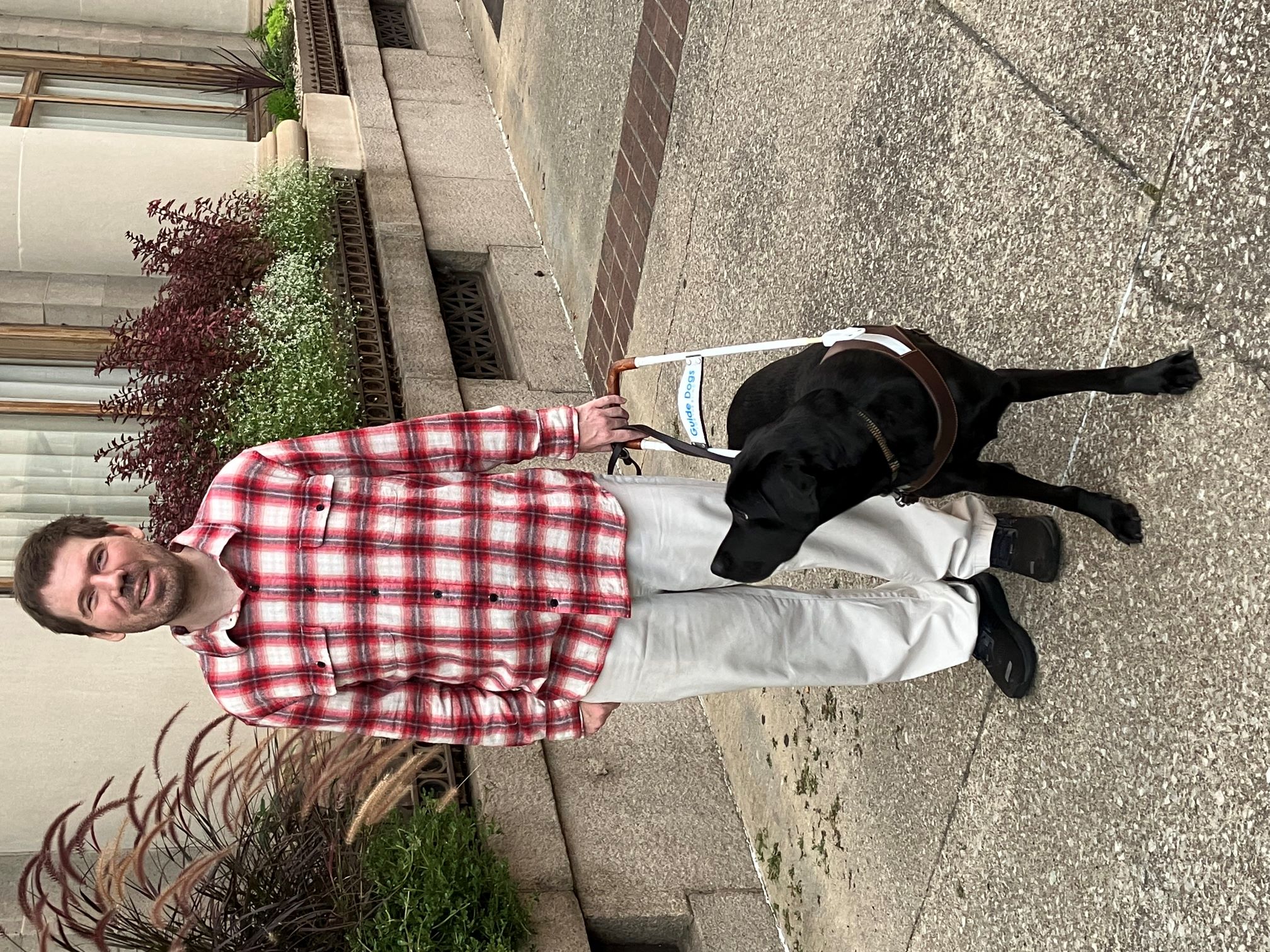 Aaron Preece with his black lab guide dog, Dunsmuir. 