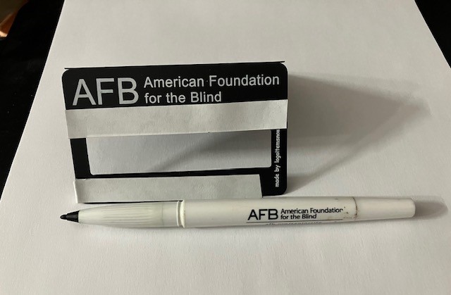 A bold line pen and signature guide. The guide has a die-cut rectangular opening.