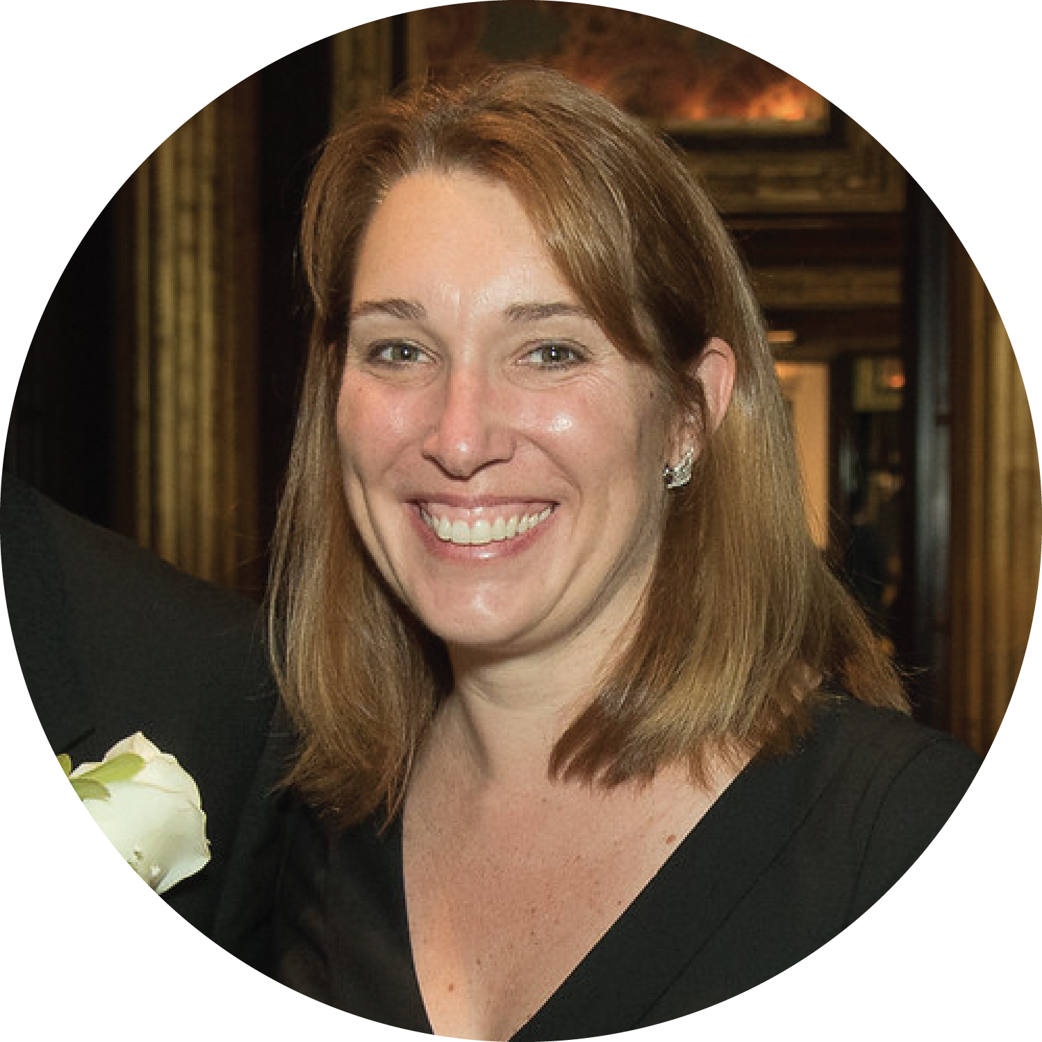 A smiling woman with shoulder-length brown hair.