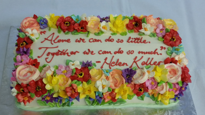 Cake covered in flowers and a quotation celebrating Helen Keller's birthday